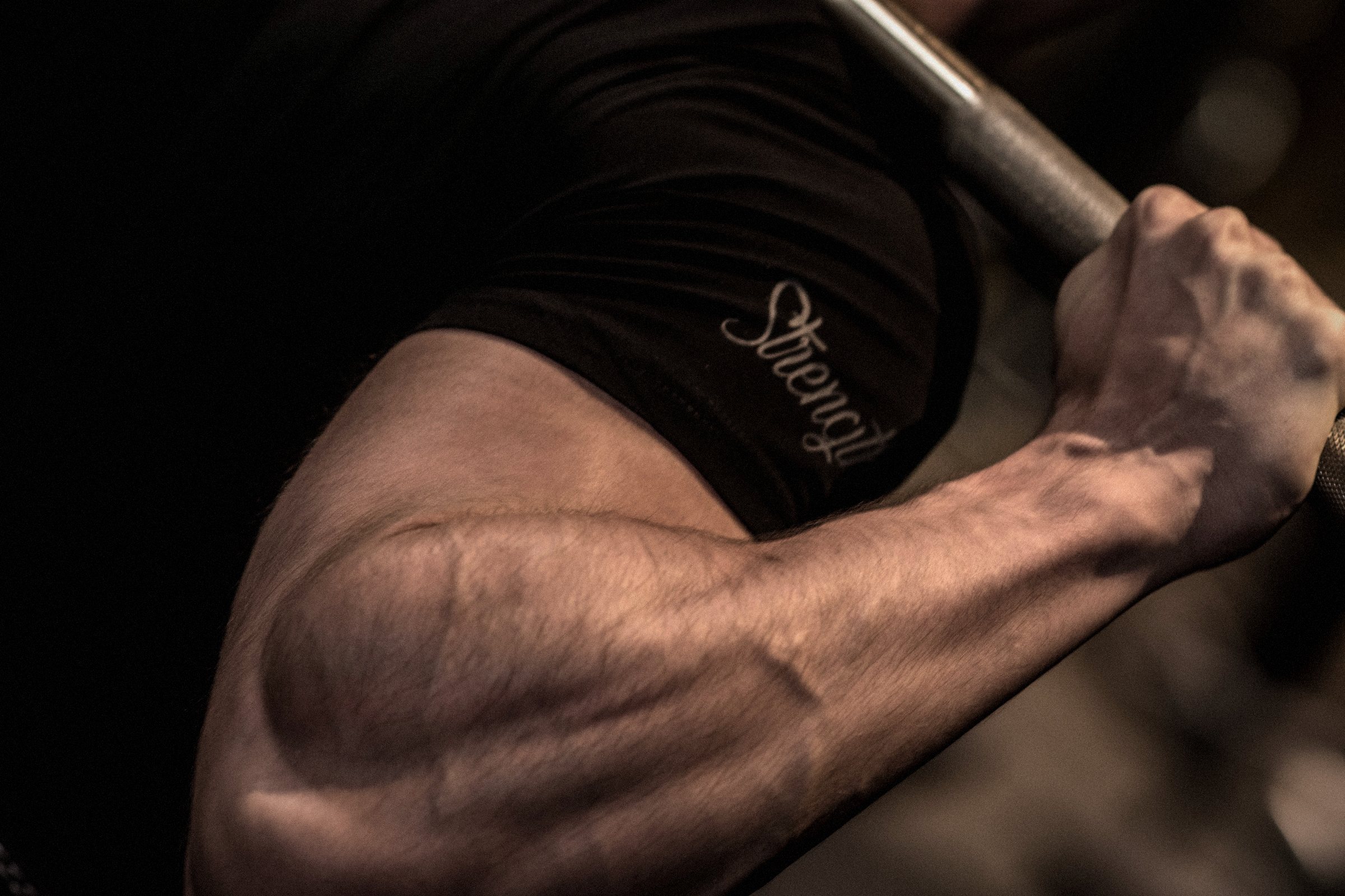 Sleeve script detail on the Signature Tee